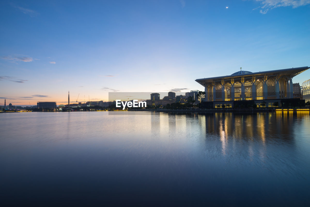 Tuanku mizan zainal abidin mosque by lake against sky