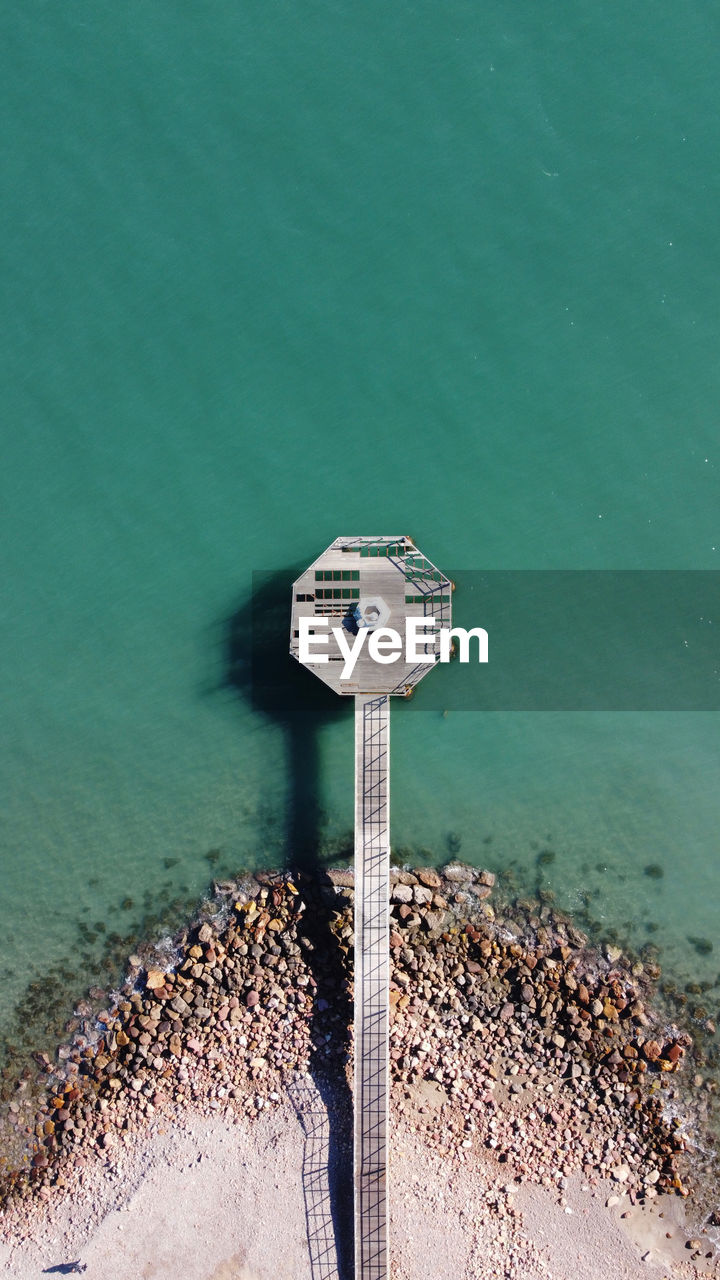 High angle view of coin-operated binoculars by sea