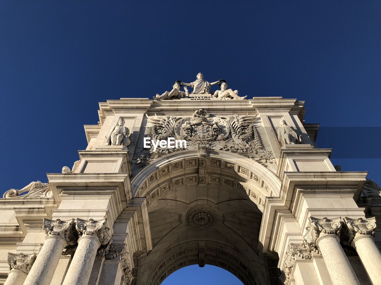 Low angle view of historic building against blue sky