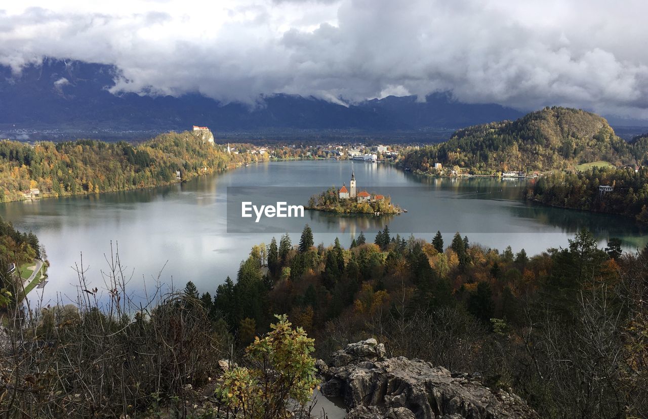 Scenic view of lake by trees against sky