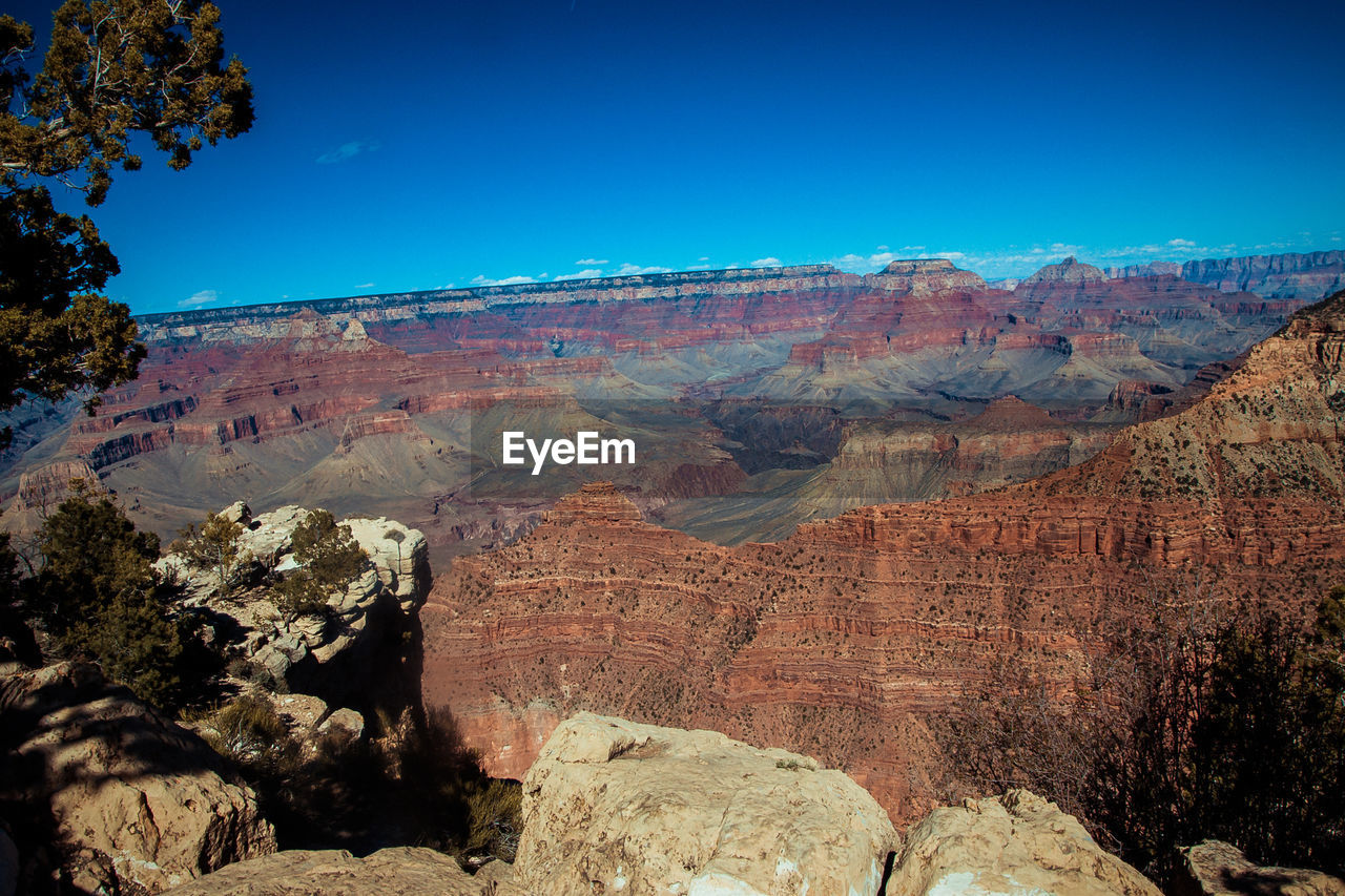 VIEW OF ROCK FORMATIONS AGAINST CLEAR BLUE SKY