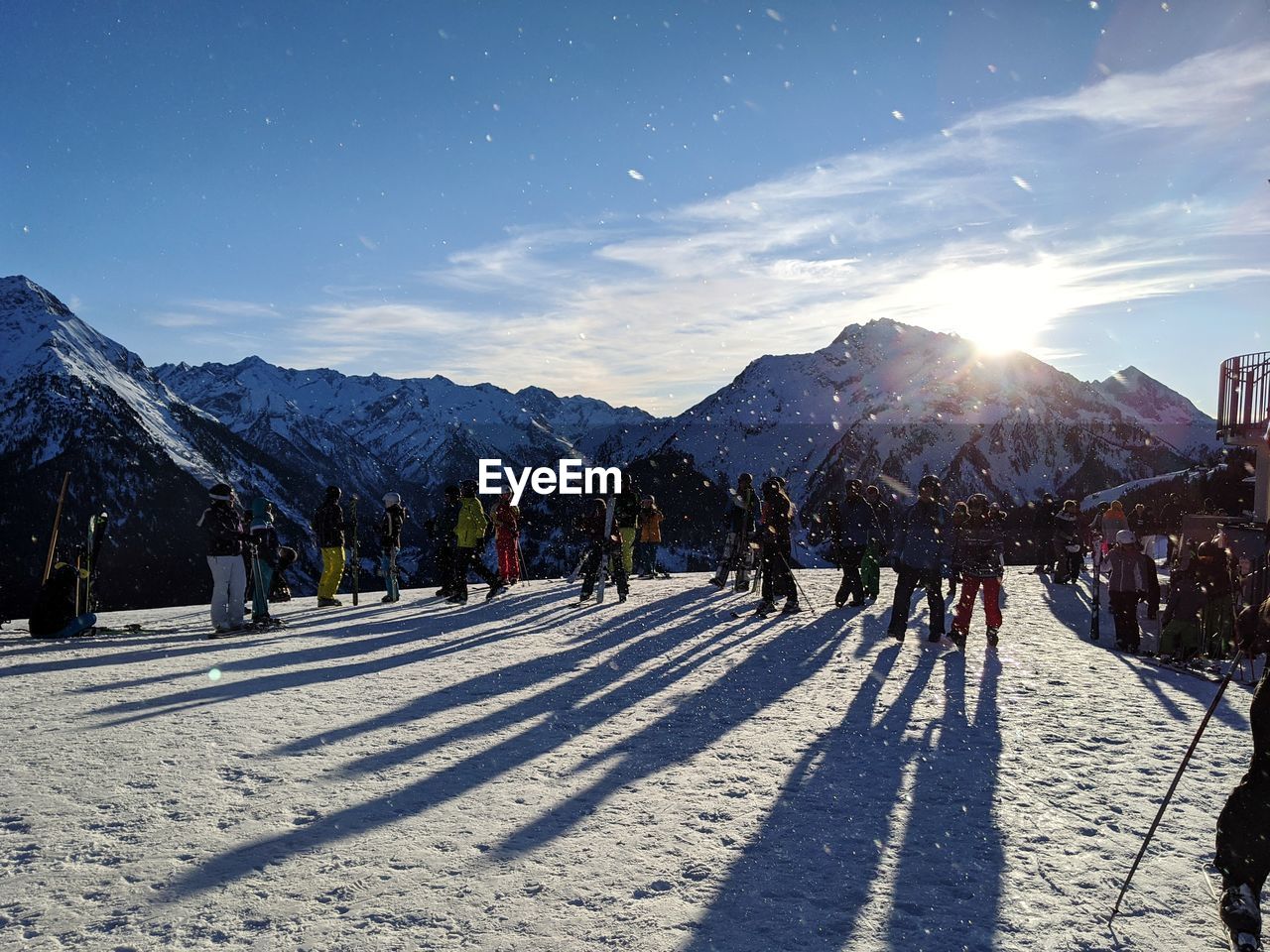 People on snowcapped mountain against sky