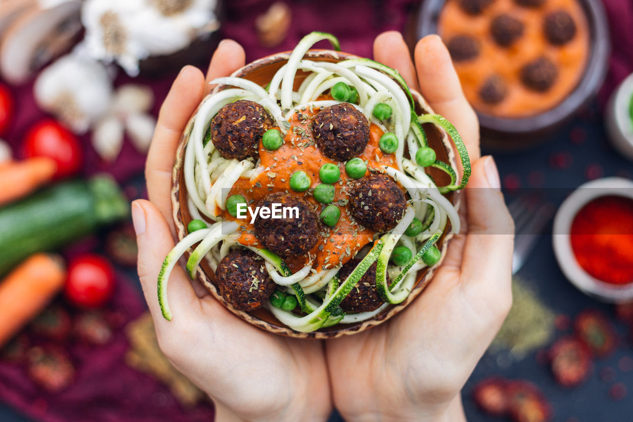 HIGH ANGLE VIEW OF PERSON HAND HOLDING VEGETABLES