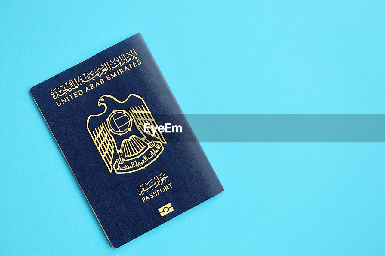 identity document, passport, blue, text, studio shot, copy space, no people, colored background, indoors, single object, travel