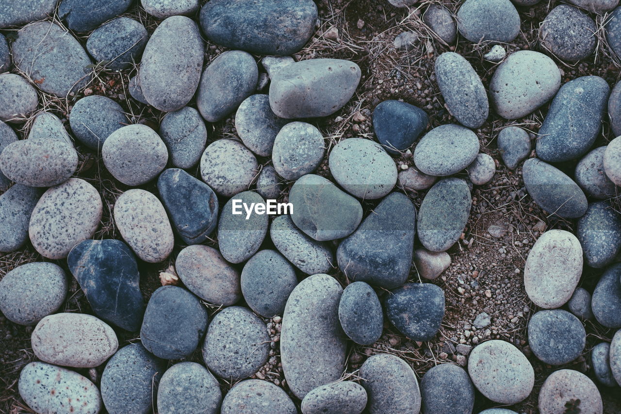 High angle view of pebbles on sand