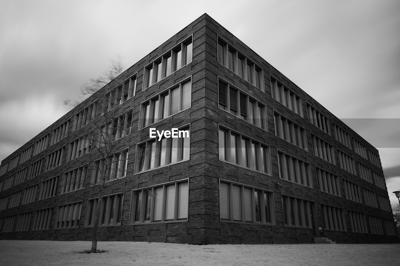 Low angle view of building against cloudy sky