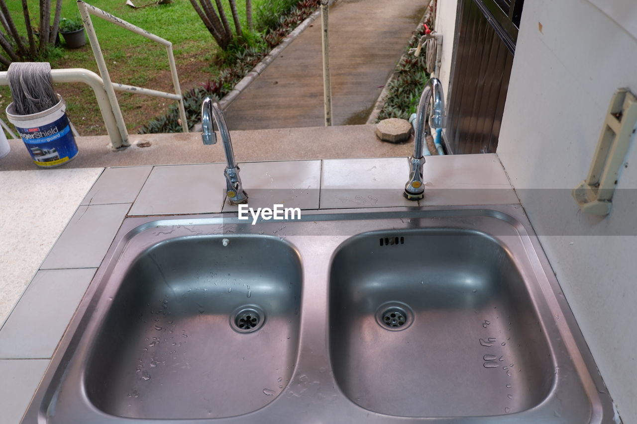 HIGH ANGLE VIEW OF FAUCET IN ROW