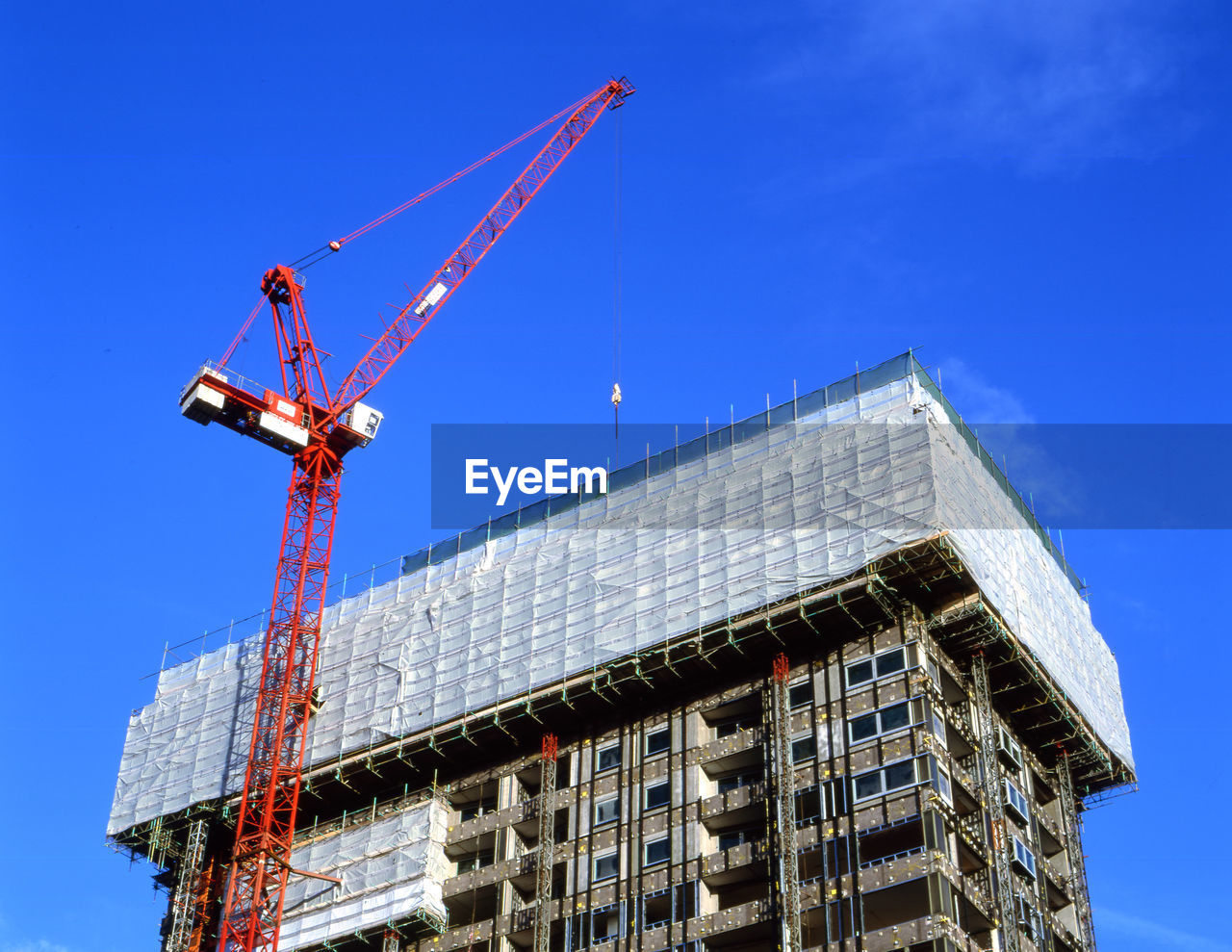 Low angle view of building under construction against sky