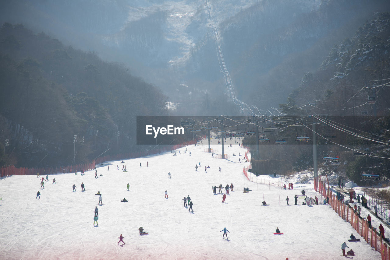 High angle view of people on snow covered land