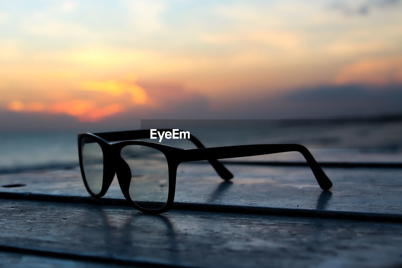 Cylindrical glasses on the beach at sunset