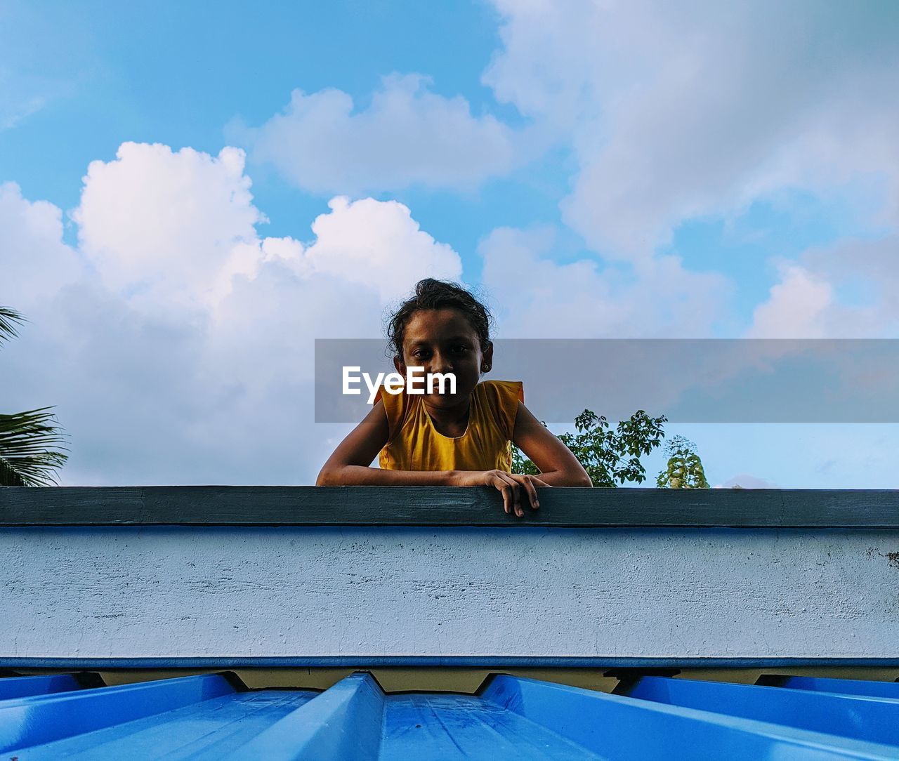 Portrait of girl against blue sky