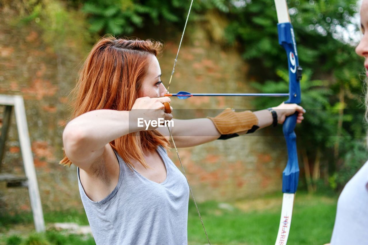 Close-up of woman practicing archery