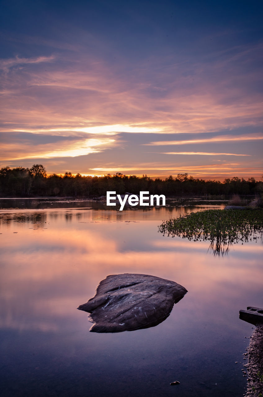 SCENIC VIEW OF LAKE AT SUNSET