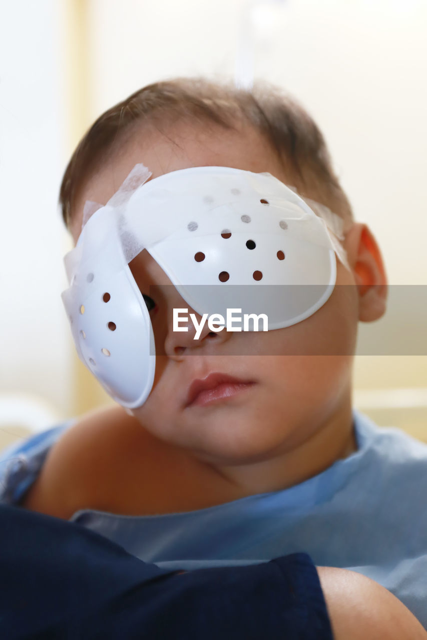 Close-up of boy with bandage on eyes