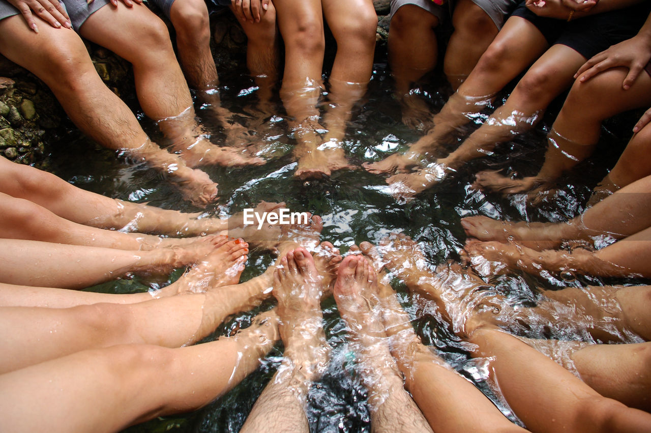 Low section of people sitting in water