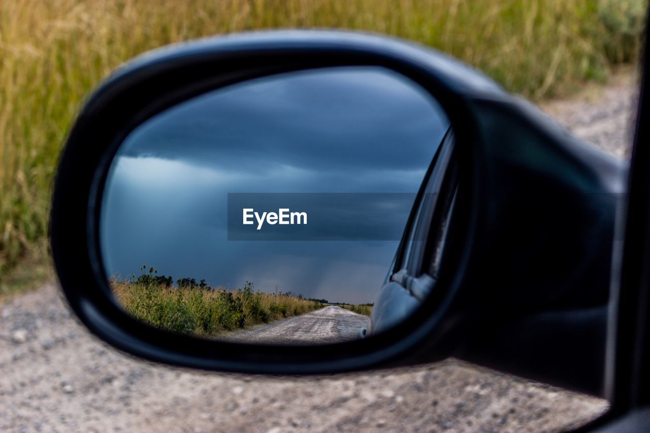 REFLECTION OF CAR ON SIDE-VIEW MIRROR OF A SIDE