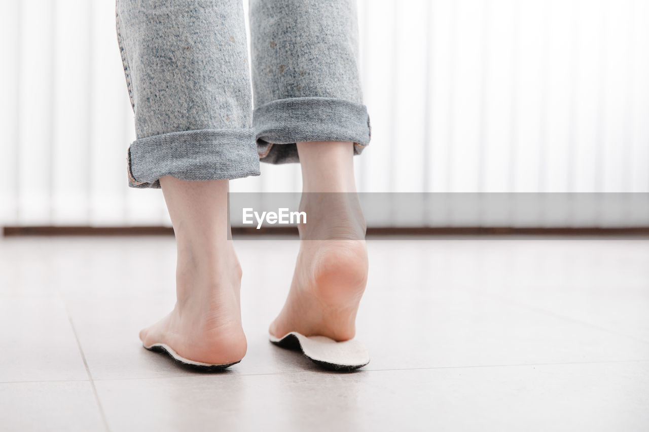 low section of woman walking on floor