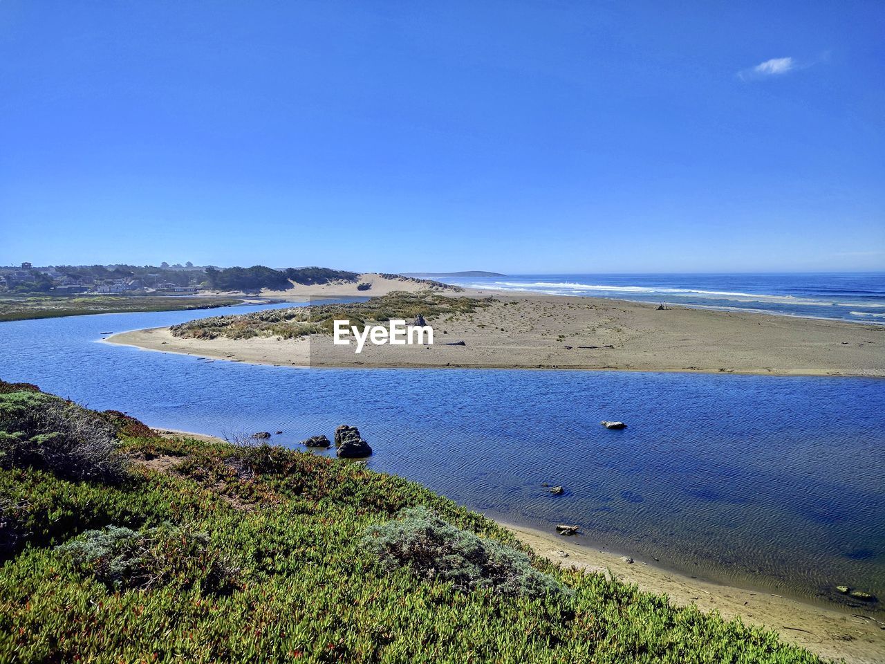 Scenic view of sea against clear blue sky