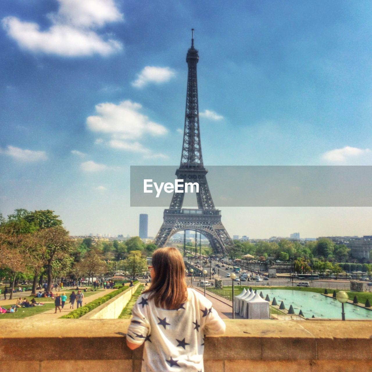 Rear view of young woman against eiffel tower