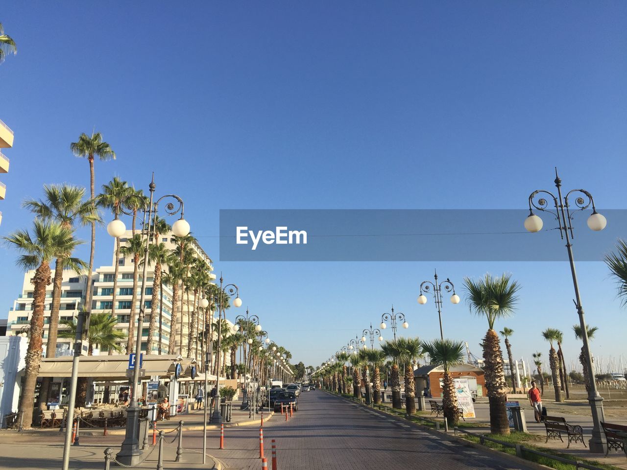 View of empty road against blue sky