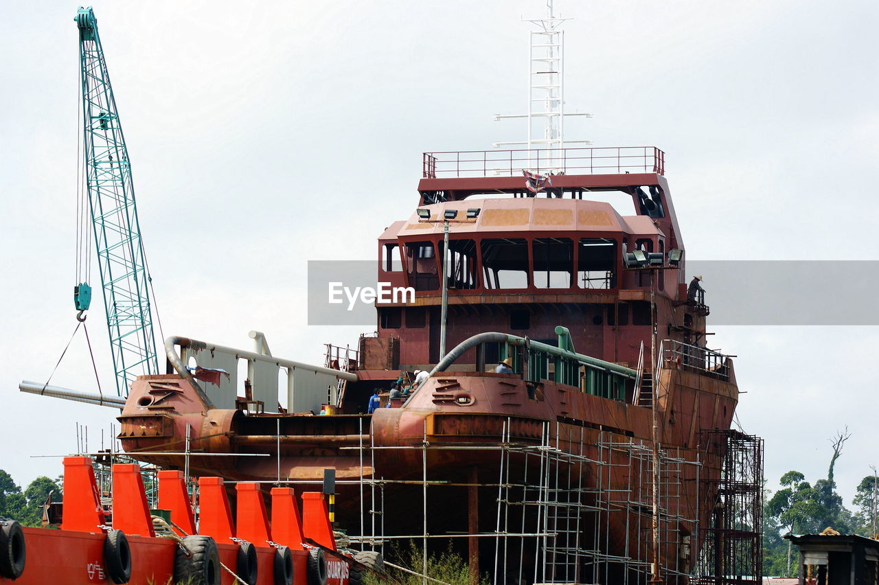 Environment works to build and repair tugboats and cargo ships at shipyard