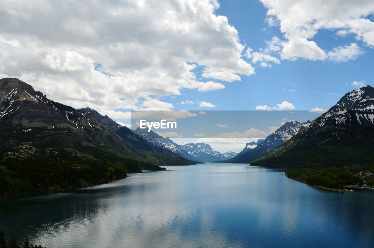 Scenic view of lake and mountains against sky