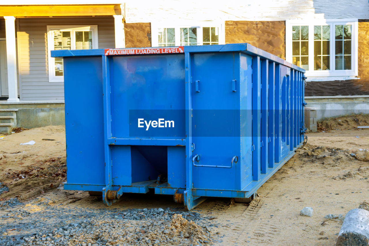 BLUE METALLIC STRUCTURE AGAINST BUILDINGS