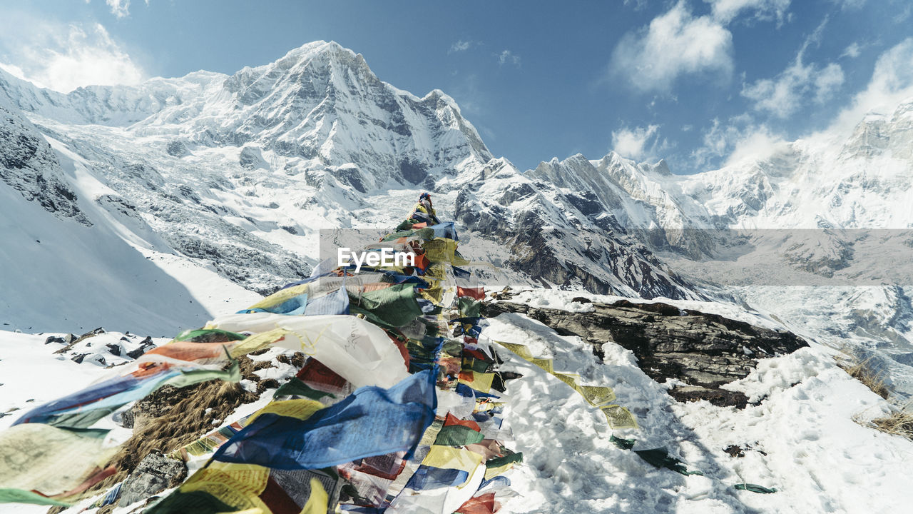 Prayer flags on machapuchare snowcapped mountains against sky