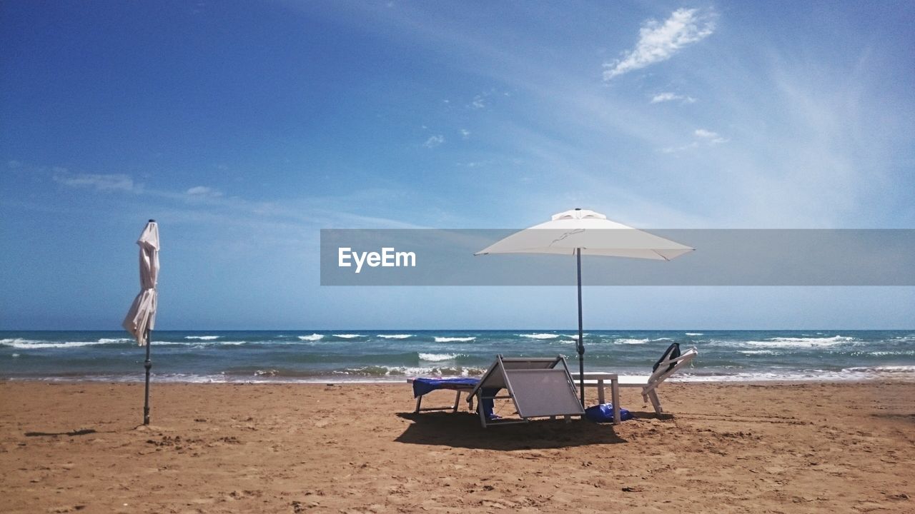 Table and beach umbrellas on beach