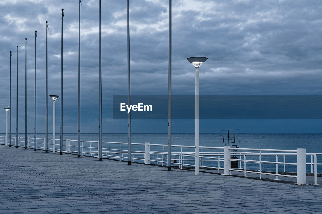 Flagpoles lined up on a promenade of the baltic sea