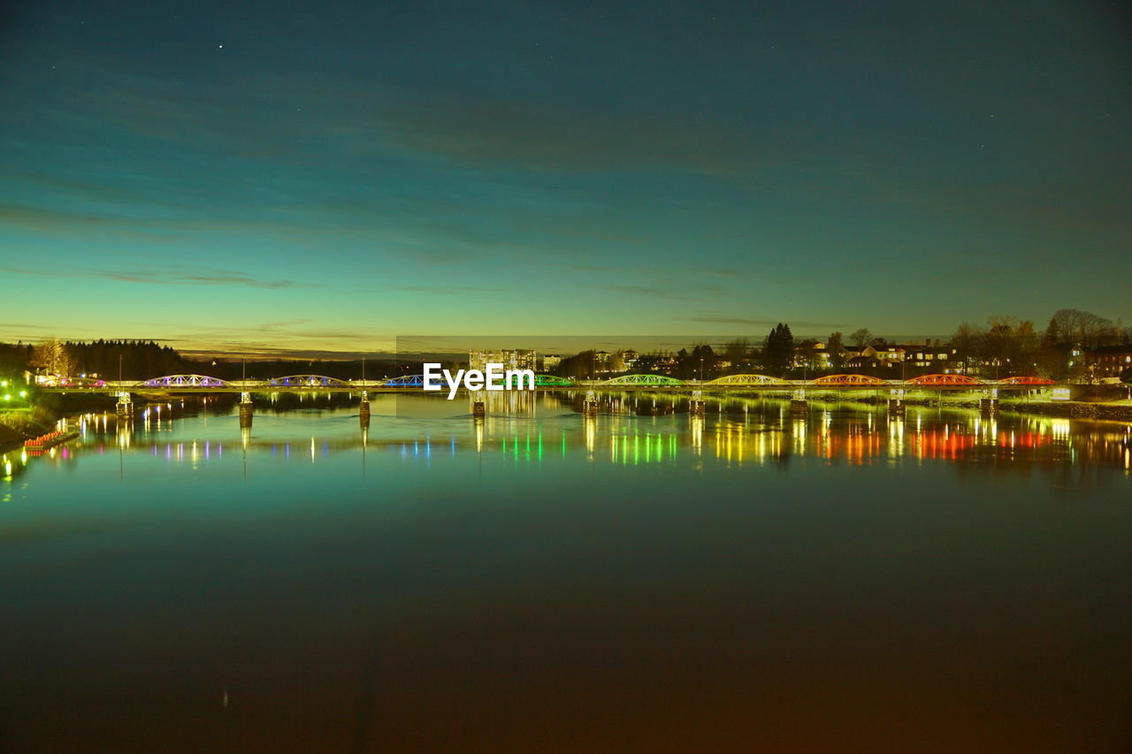 reflection, water, dusk, sky, night, architecture, horizon, built structure, building exterior, evening, illuminated, nature, waterfront, no people, city, light, building, lake, beauty in nature, scenics - nature, tranquility, outdoors, tranquil scene, cityscape, sunset, travel destinations, cloud