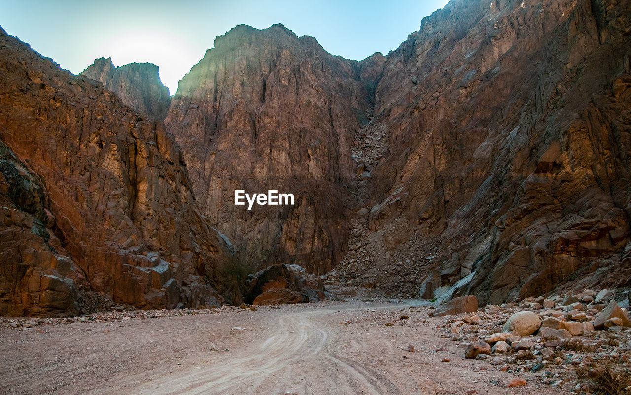 Dirt road against rock formation