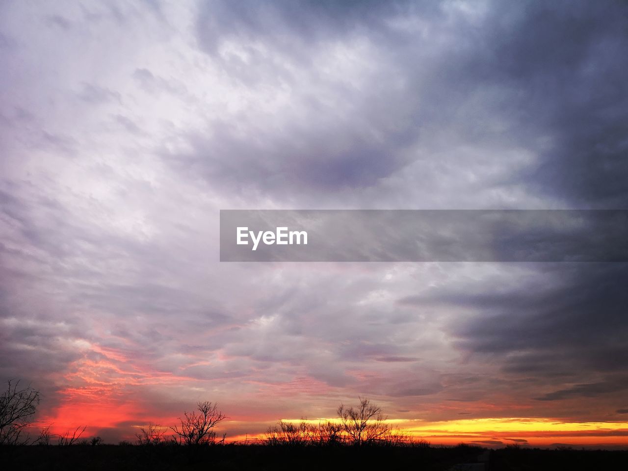 DRAMATIC SKY OVER SILHOUETTE LANDSCAPE