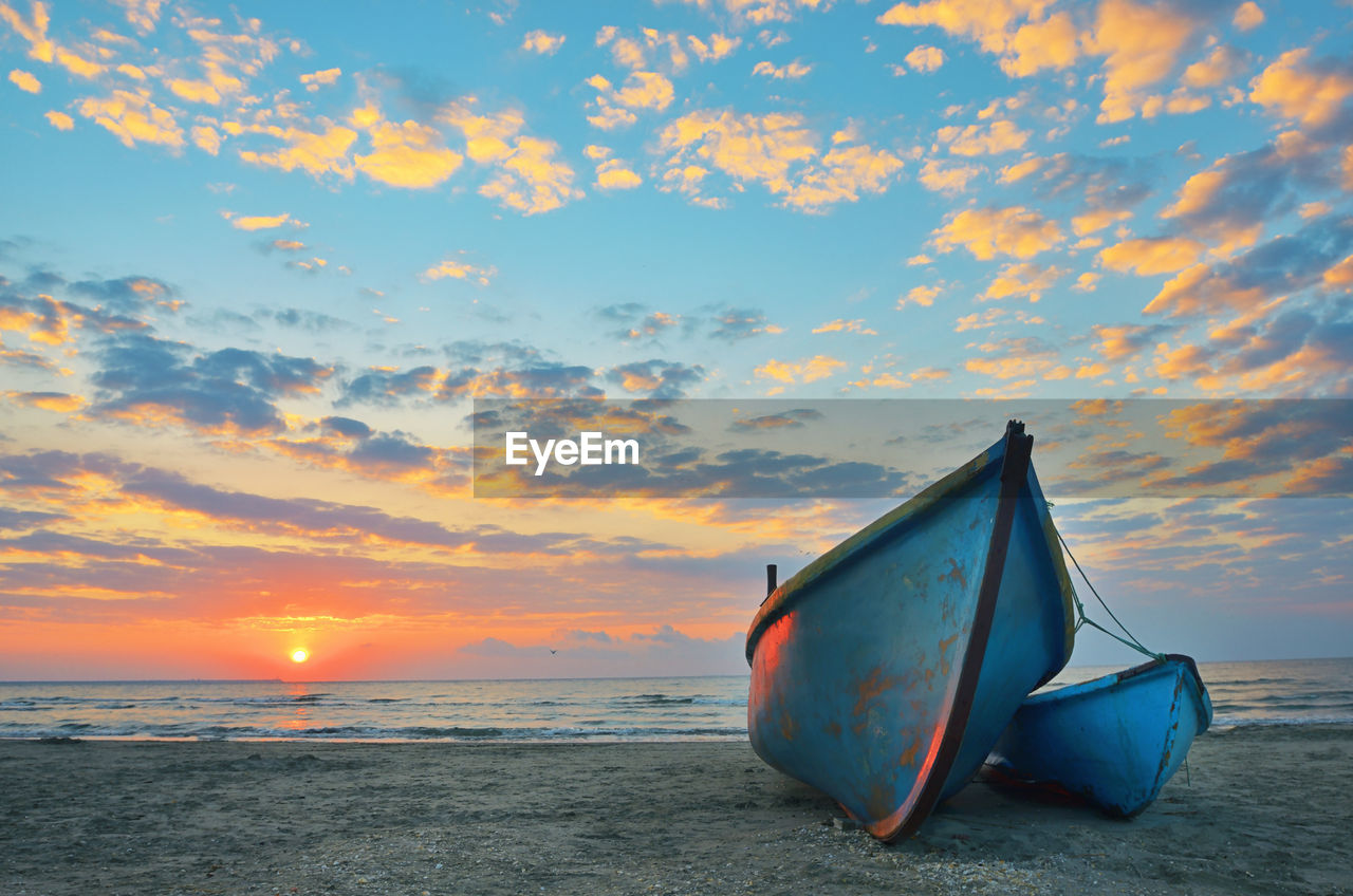 Sunrise at black sea over an old wooden fishing boats