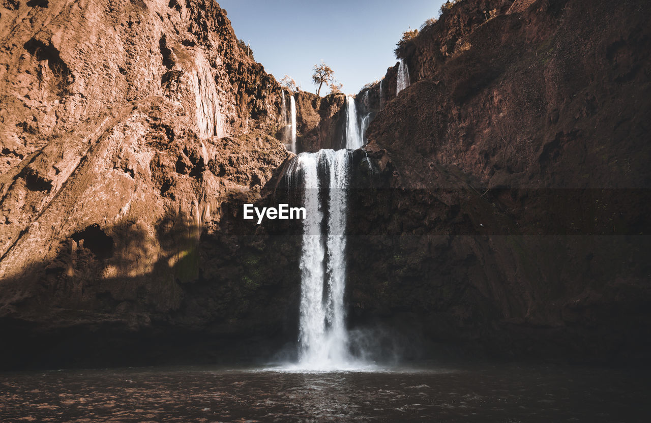 scenic view of waterfall in forest