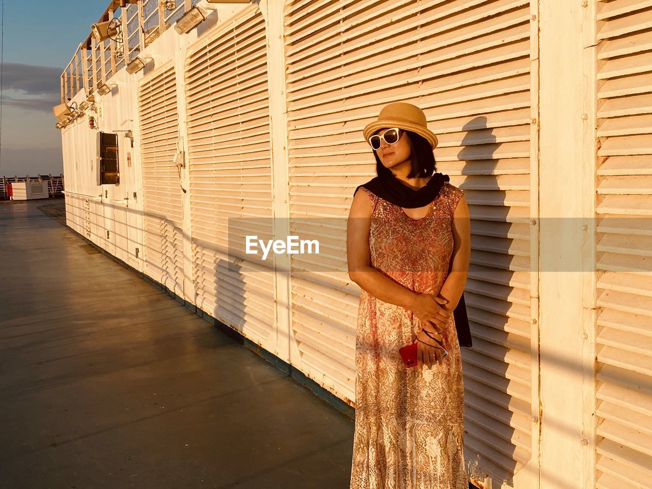 Portrait of woman standing against building