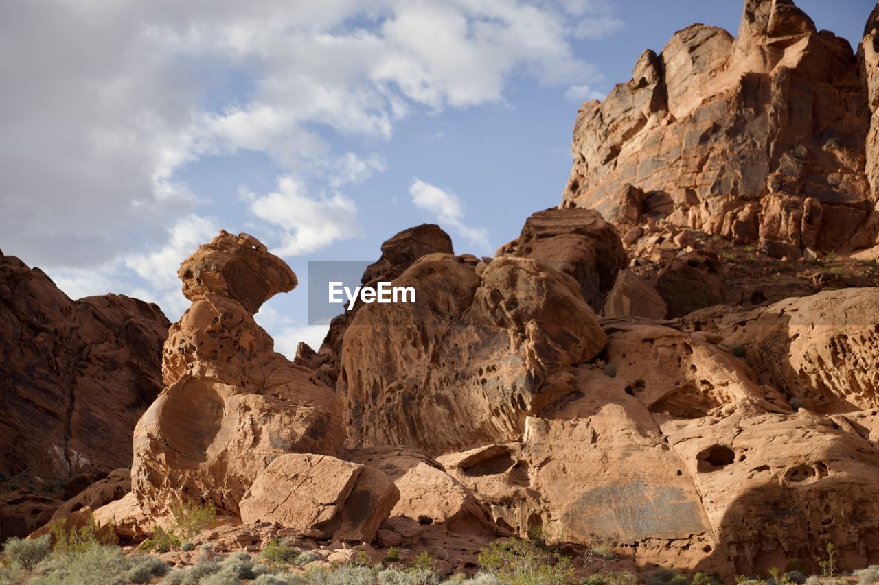 rock, rock formation, sky, arch, nature, landscape, environment, scenics - nature, land, valley, travel destinations, natural environment, cloud, beauty in nature, wadi, travel, desert, no people, non-urban scene, geology, mountain, outdoors, semi-arid, formation, climate, tranquility, physical geography, ancient history, tourism, sunlight, eroded, terrain, day, sandstone, plant, extreme terrain, fossil, wilderness, animal wildlife, arid climate