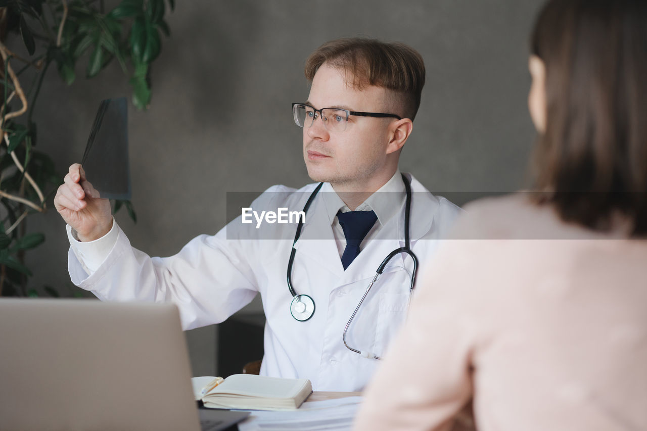 smiling female doctor examining patient in office