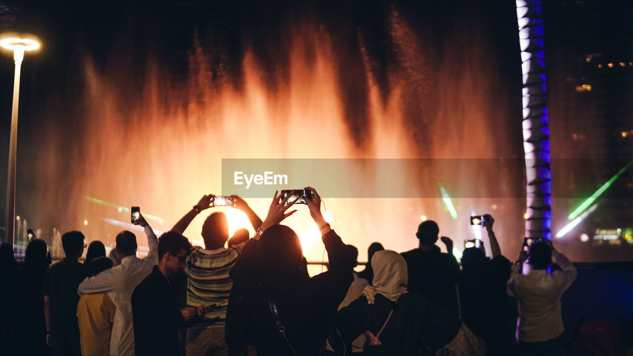 People enjoying music concert at night during jeddah season