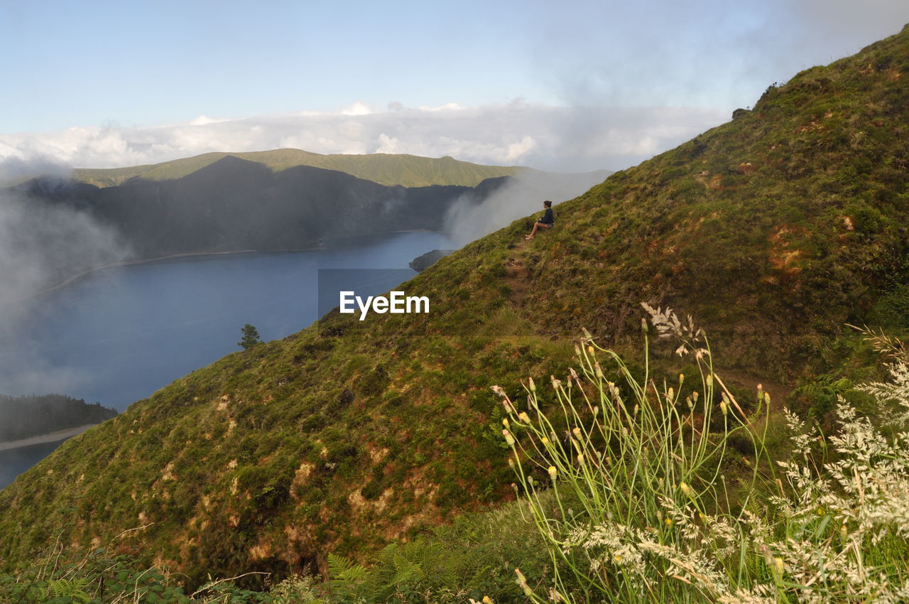 Scenic view of mountains against cloudy sky