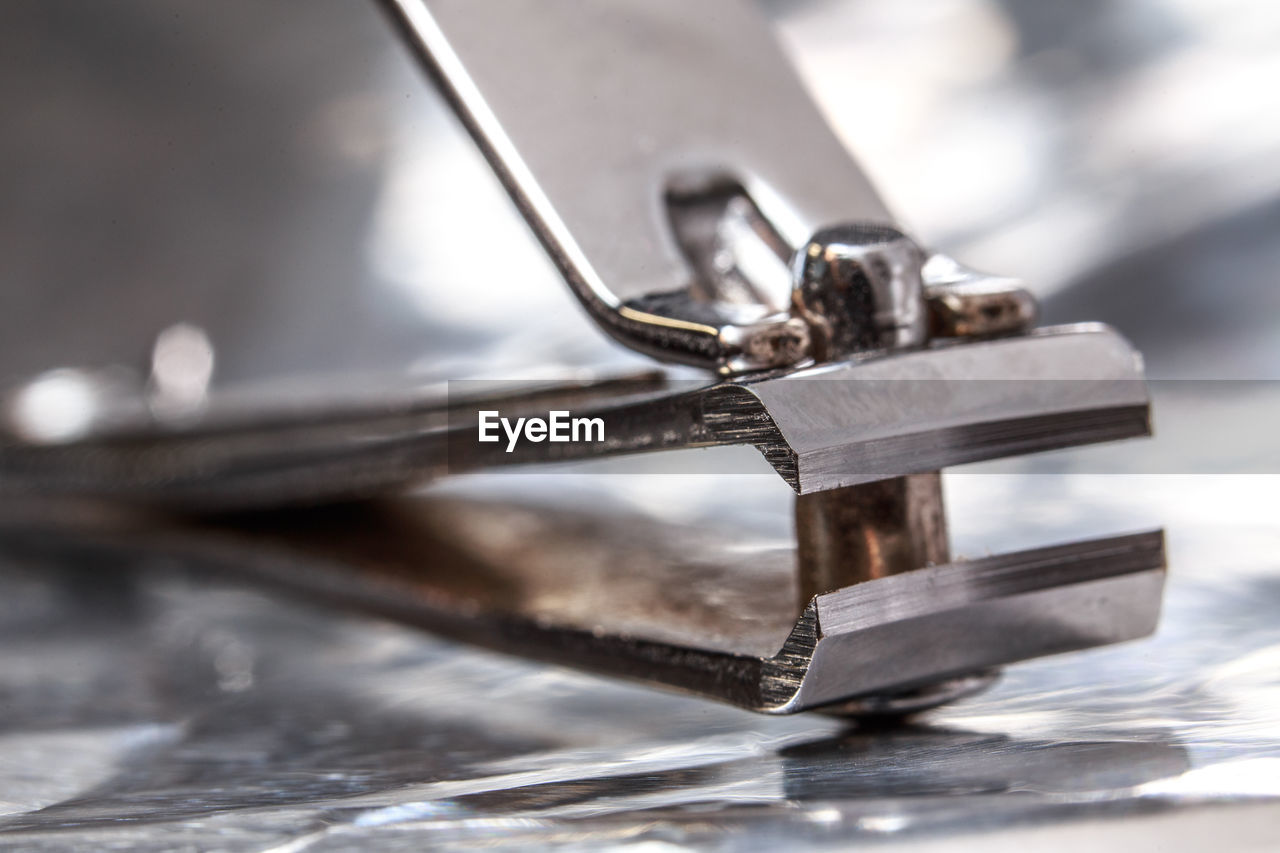 Close-up of nail clipper on table