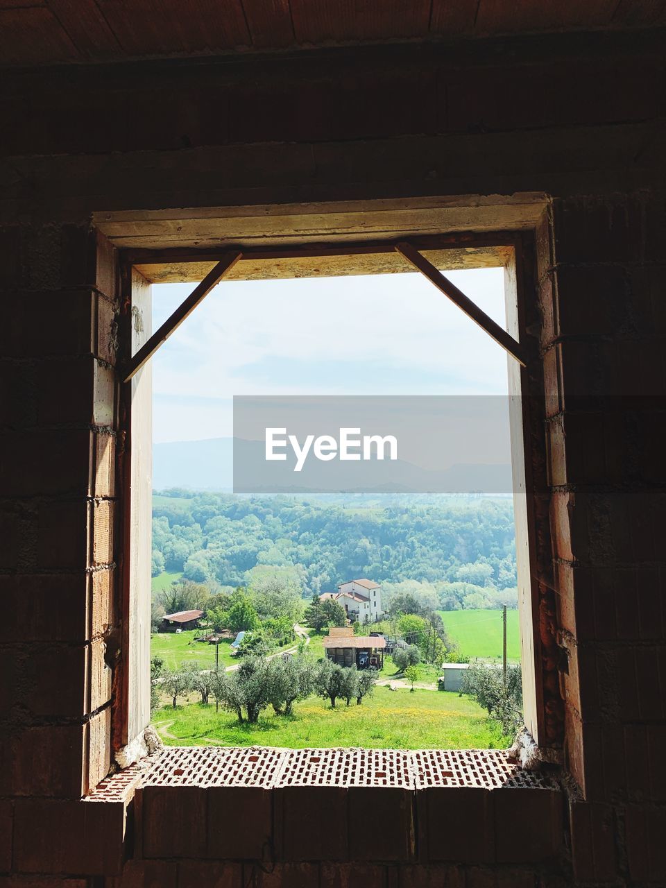 LANDSCAPE SEEN THROUGH WINDOW OF HOUSE