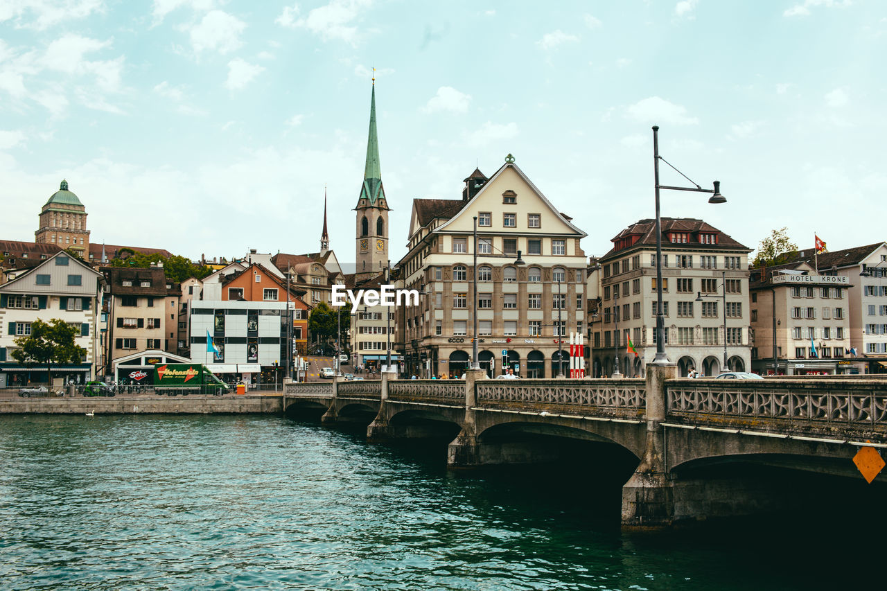 BRIDGE OVER RIVER AGAINST BUILDINGS