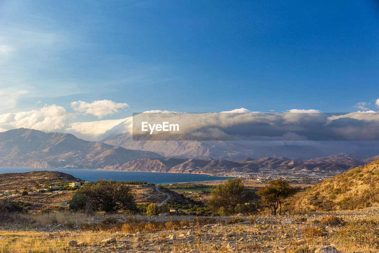 Scenic view of mountain against cloudy sky