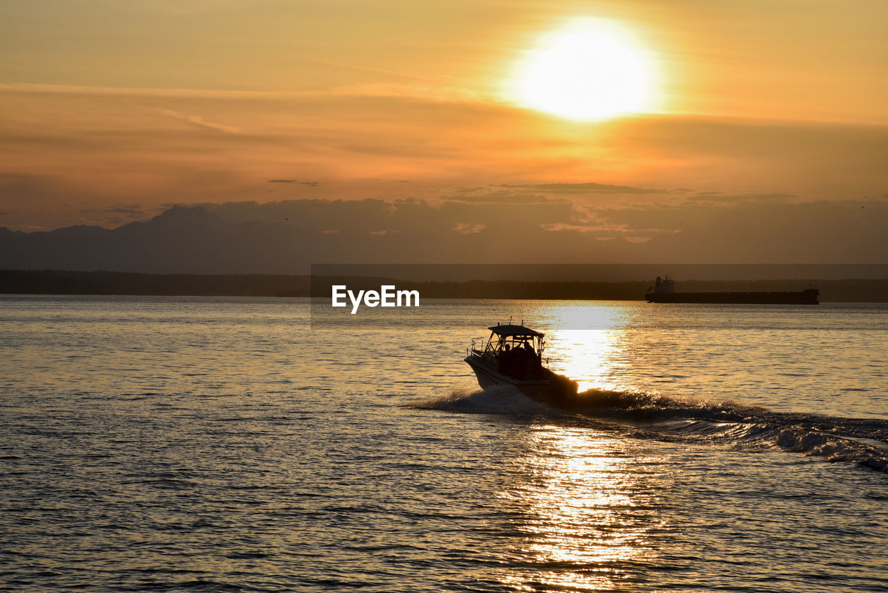 Silhouette boat on sea against sky during sunset