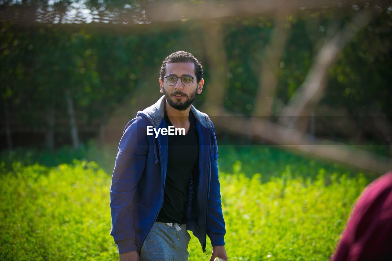 Young man standing at park