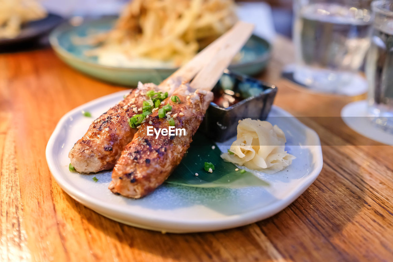 food and drink, food, plate, dish, meal, fast food, freshness, table, meat, healthy eating, vegetable, cuisine, wood, no people, restaurant, dinner, indoors, breakfast, gourmet, business, produce, wellbeing, close-up, crockery, seafood, focus on foreground, brunch, selective focus, animal