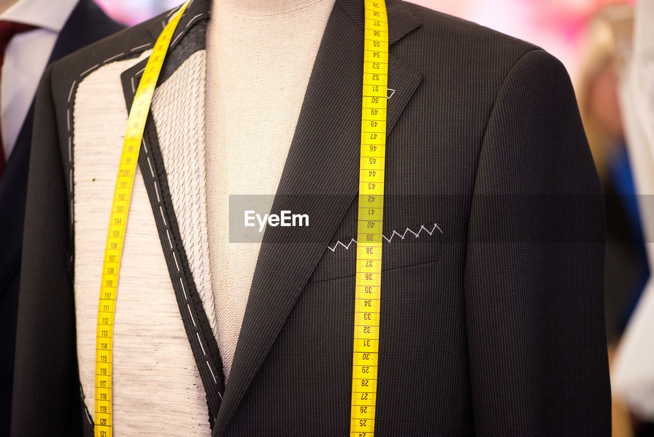 Suit with tape measure on mannequin