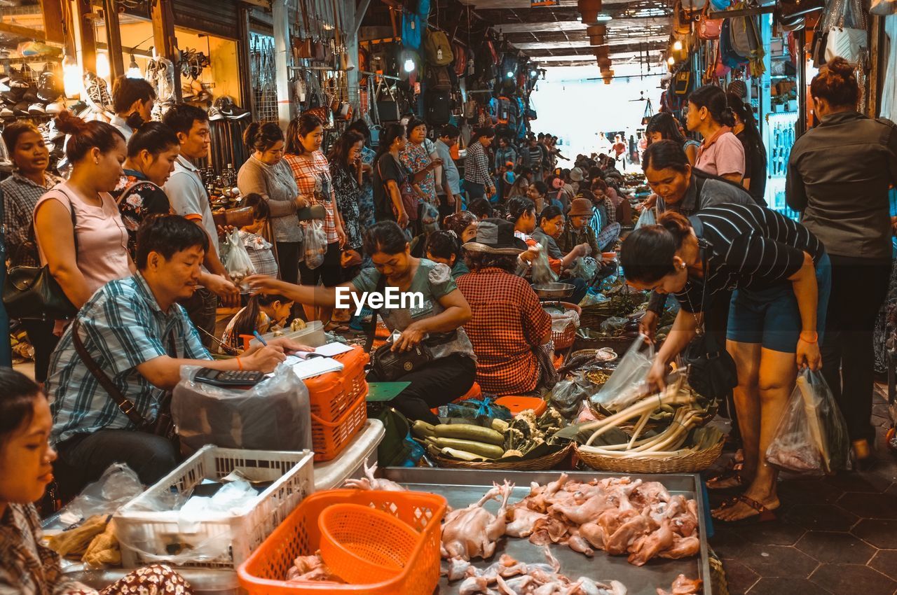 PEOPLE IN MARKET STALL