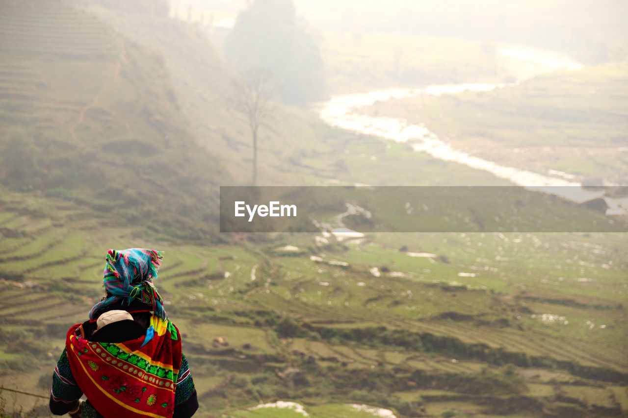 A woman from the flower hmong tribe trekking along the rice terraces